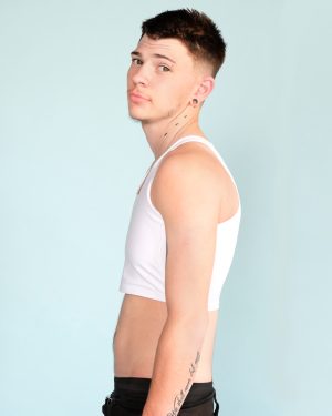 Model wearing long white mid length binder in profile showing a flat chest