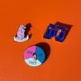 Hankie pin pronouns pin and platypus pin on orange