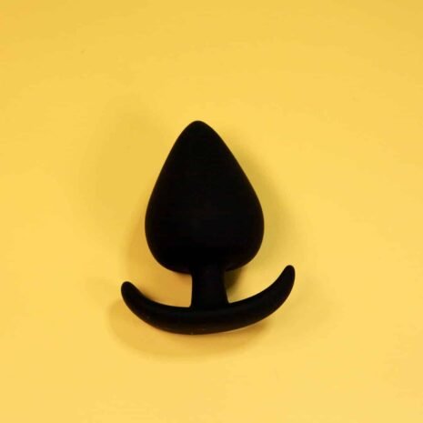 spade on yellow Silicone black spade butt plug with comfort wearable base
