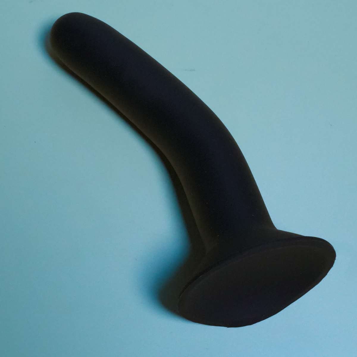 Black Ainsley toy with suction cup base silicone on blue background